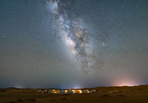 Aerial view of cityscape of Merzouga under Milky Way in the sky in Sahara desert